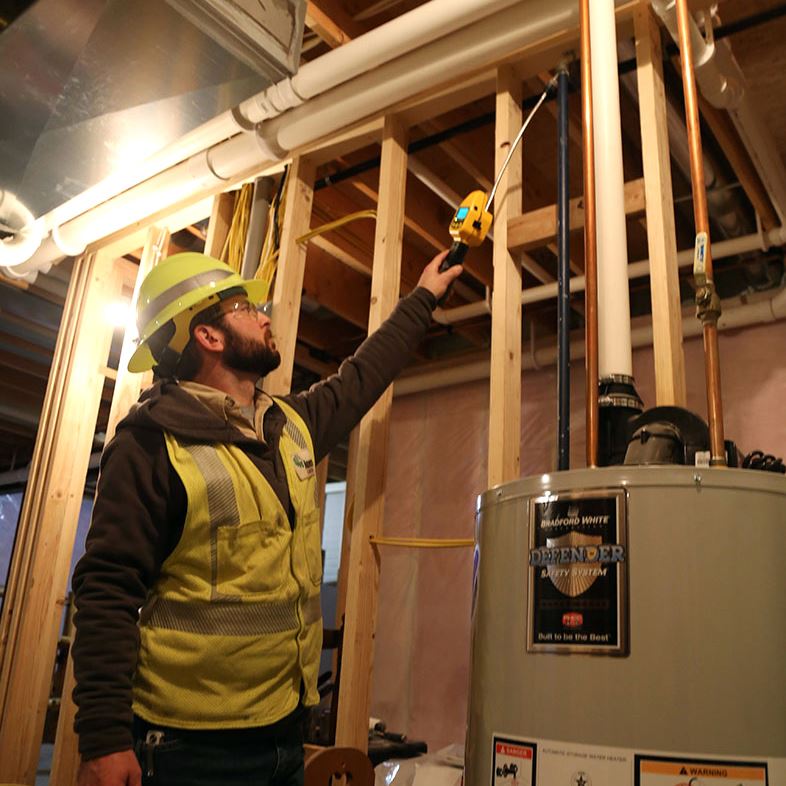 Ameren worker by a water heater